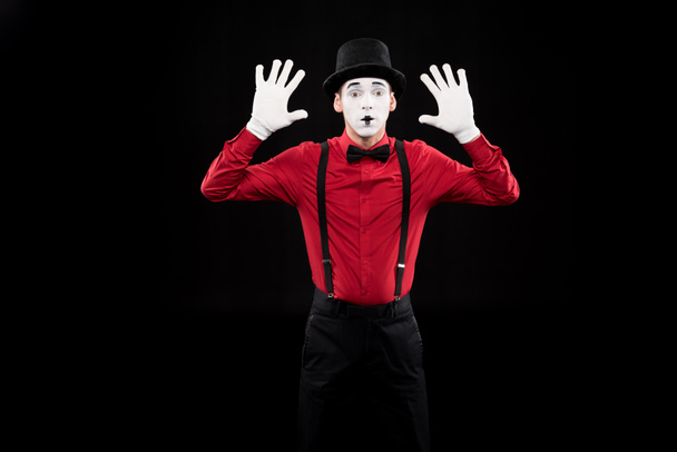 mime with hands up isolated on black - Photo, Image