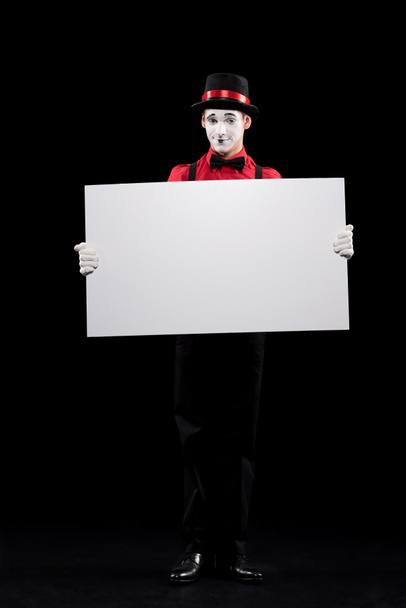 mime holding empty board isolated on black - Photo, Image