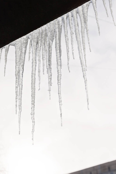 Vaarallisia jääpuikkoja roikkuu luminen katto talon. lso kiho
 - Valokuva, kuva
