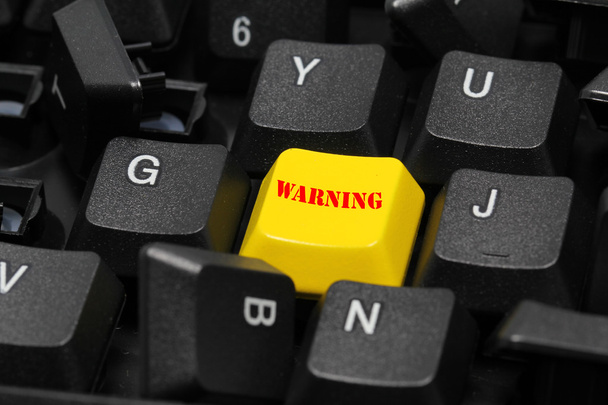 λέξη της προειδοποίησης στο κίτρινο και μαύρο πληκτρολόγιο κουμπί - Φωτογραφία, εικόνα