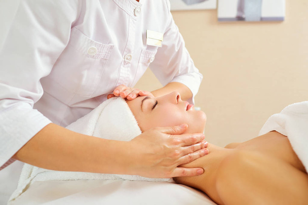 Beautiful woman at a facial massage at a spa salon - Фото, зображення