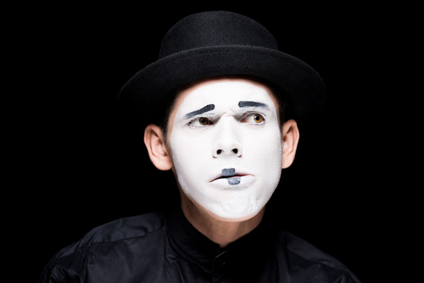 thoughtful mime with makeup isolated on black - Foto, Imagen