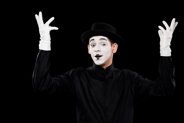 mime showing hands and looking at camera isolated on black - Photo, Image
