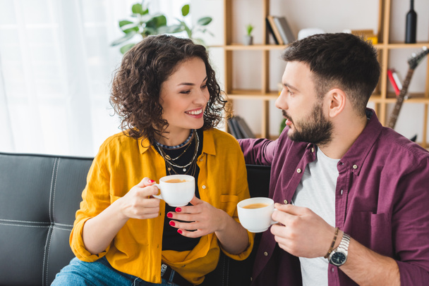 Smiling woman drinking coffee with boyfriend - Fotografie, Obrázek