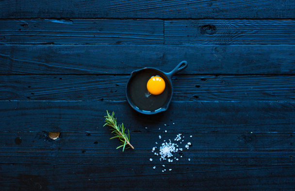 Chicken egg on a dark wooden background, free space for text. - Foto, imagen