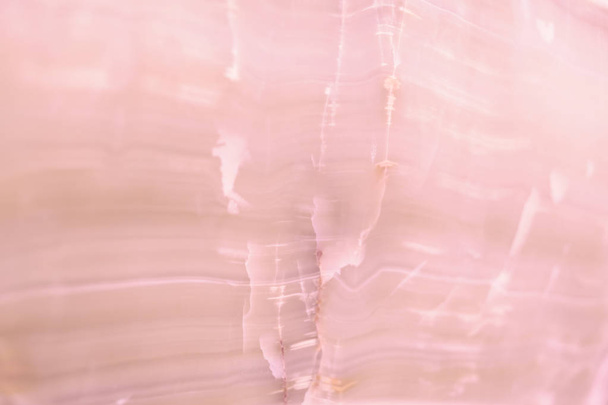 Lightened slices marble onyx. Horizontal image. Warm pink colors. Beautiful close up background - Photo, Image