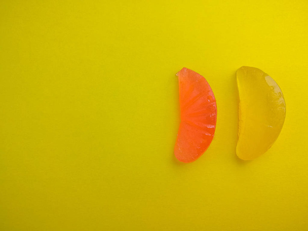 Two jelly candies on a yellow background - Zdjęcie, obraz