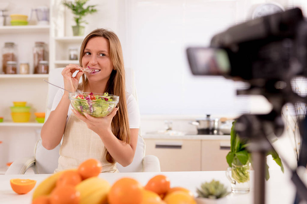 Beautiful young woman filming her blog broadcast about healthy food at the home. - Fotografie, Obrázek