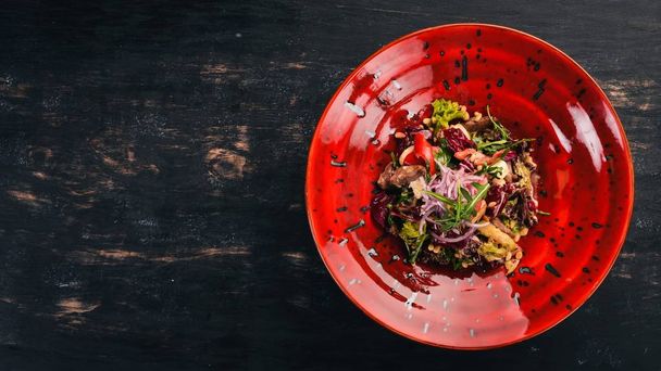 Veal Salad with Pine Nuts and Vegetables. Top view. Free space for your text. On a wooden background. - Foto, afbeelding