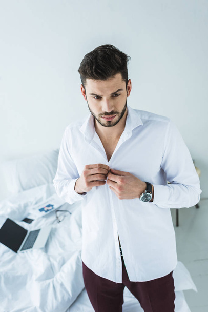 businessman wearing white shirt in bedroom - Fotoğraf, Görsel
