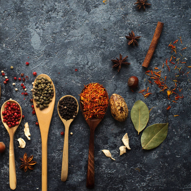 Various indian spices in wooden spoons, herbs and nuts - 写真・画像