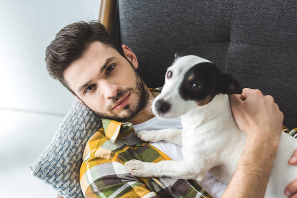 handsome man and jack russell terrier dog looking at camera - Foto, imagen
