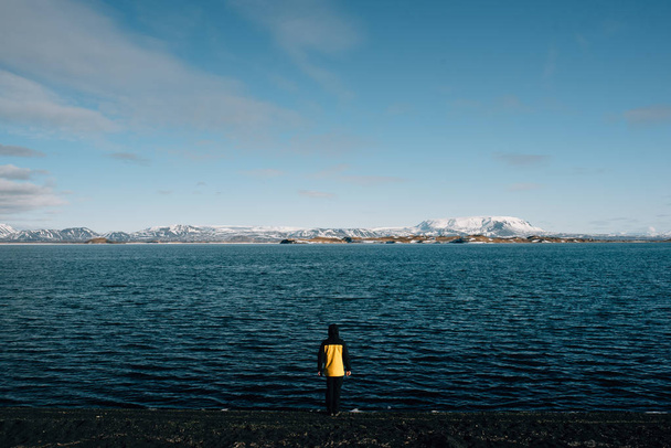 A man on the shores of Lake Myvat - Φωτογραφία, εικόνα