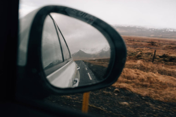 Reflection of mountains in the mirror of a moving car - Фото, зображення