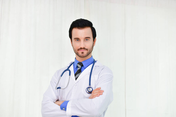Smiling doctor posing in the office, he is wearing a stethoscope - Foto, Imagem