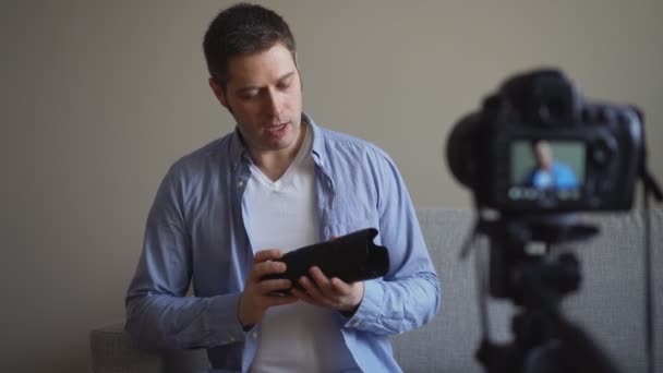 Handsome man making video blog about photo camera lenses. - Footage, Video