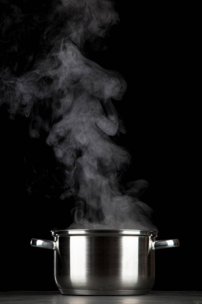 Steaming pot on black background - Фото, изображение