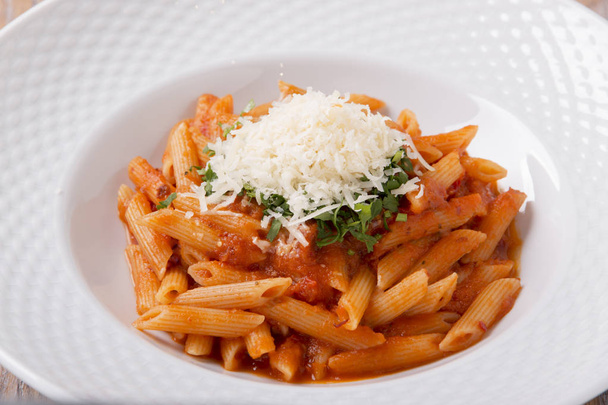 pasta penne with parmesan cheese tomato sauce greens - Foto, immagini