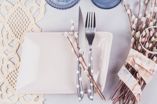  White plate, blue glass, cutlery and pussy willow  - Zdjęcie, obraz