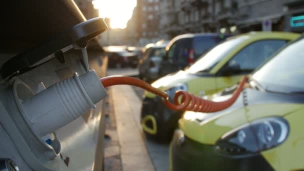 Close up of an yellow Electric Vehicles plugged in charge port. - Footage, Video