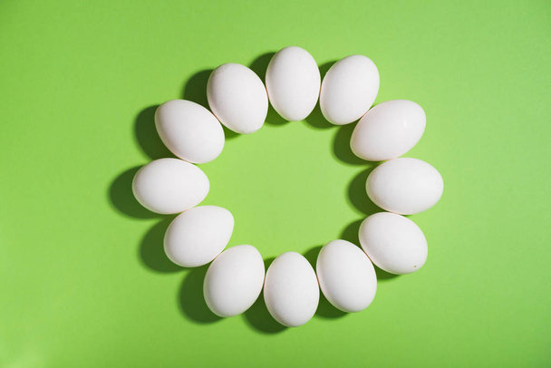 White chicken easter eggs laid out in an circle on green backgro - Фото, зображення