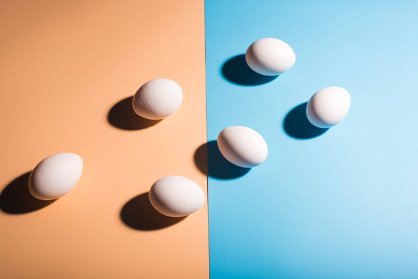 White easter eggs on blue and beige background - Fotografie, Obrázek