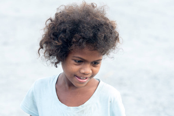 Feb 18, 2018 Aeta child with a shy smile looking at tourists, Capas - Photo, Image