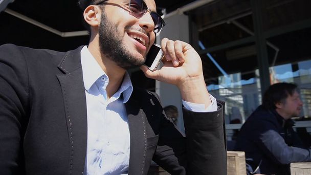 Italian boy telling jokes to wife by phone. - Photo, Image