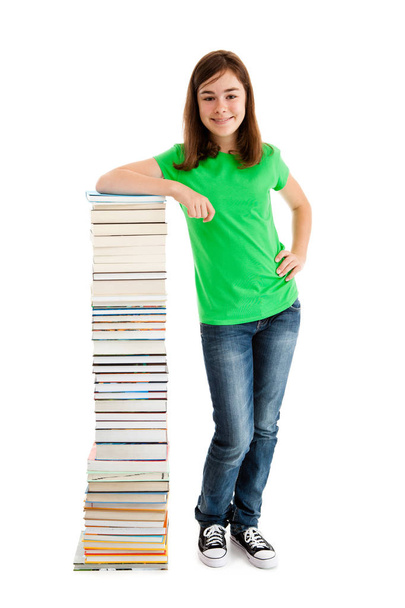 Student standing close to pile of books on white - Fotoğraf, Görsel