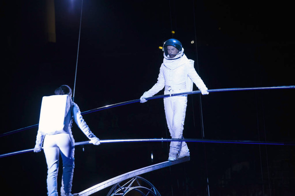 Astronaut dressed performers balance Simet Wheel during Ringling - Fotografie, Obrázek