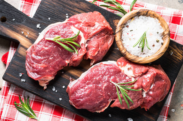 Raw beef steak rib eye with herbs. - Photo, Image