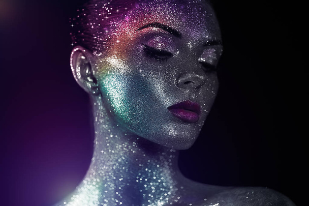Portrait of beautiful woman with sparkles on her face - Photo, Image