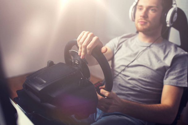 close up of man playing car racing video game - Foto, Imagem