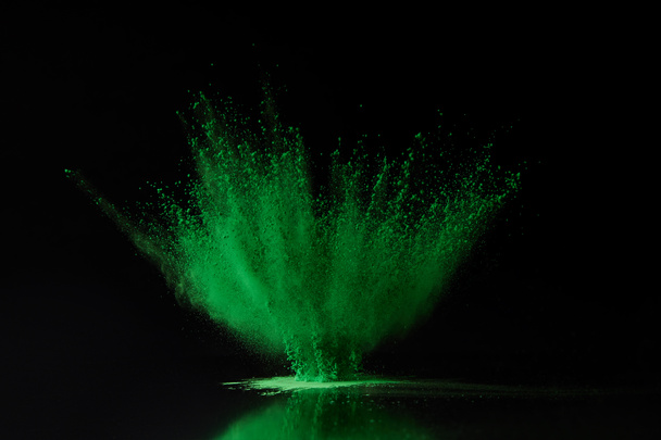 green holi powder explosion on black, Hindu spring festival - Photo, Image
