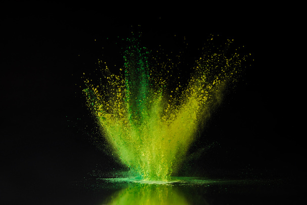 green and yellow holi powder explosion on black, traditional Indian festival of colours - Photo, Image