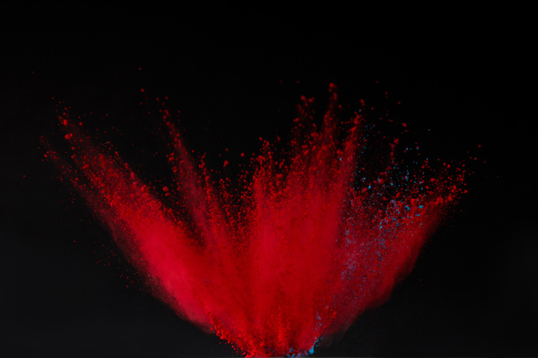 red holi powder explosion isolated on black, festival of colours - Photo, Image
