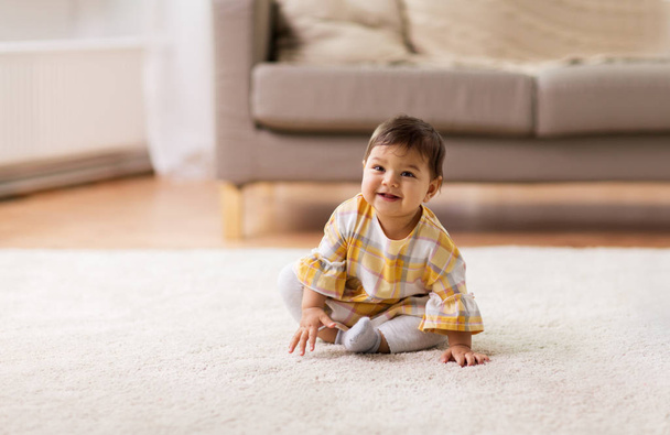 happy smiling baby girl sitting on floor home - Foto, Imagem