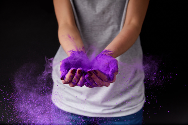 cropped view of person with purple holi paint, isolated on black - Fotoğraf, Görsel