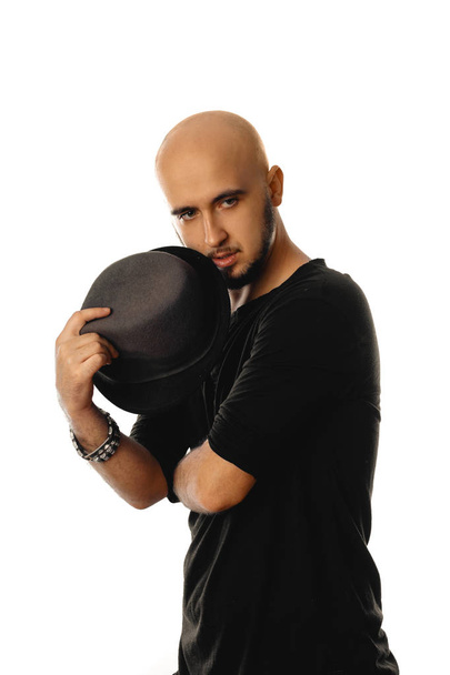 glamour unshaved man wearing black with hat in his hands - Zdjęcie, obraz