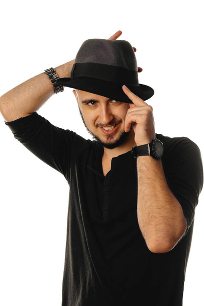 Cheerful macho man in hat looking away and smiling - Photo, Image