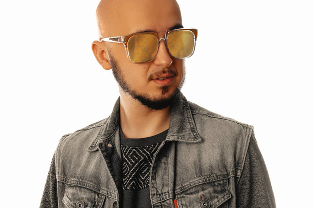 Handsome young unshaved man in sunglasses looking away - Fotografie, Obrázek