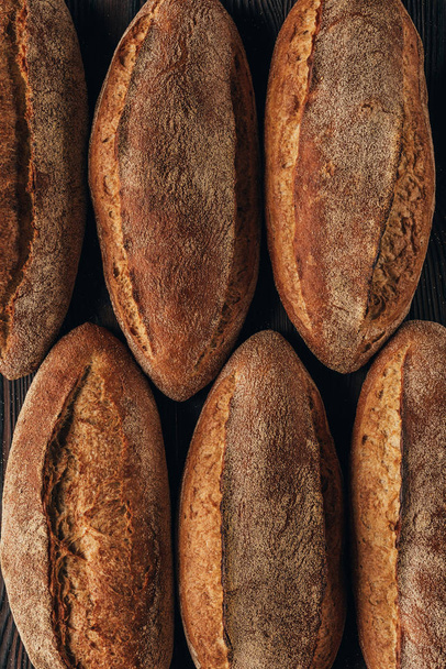 top view of freshly baked arranged loafs of bread - 写真・画像