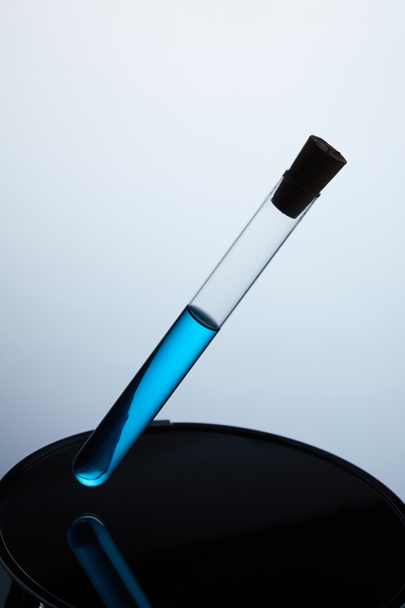 test tube filled with blue liquid on back stand - Foto, Imagen