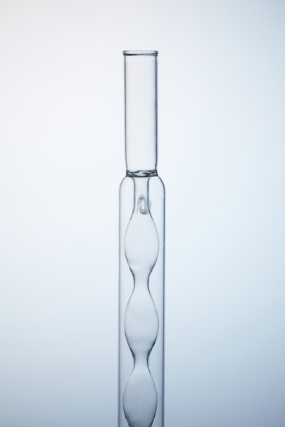 close-up shot of empty chemistry flask on grey - 写真・画像
