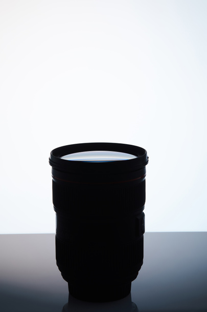 single camera lens silhouette on white - Foto, Imagem