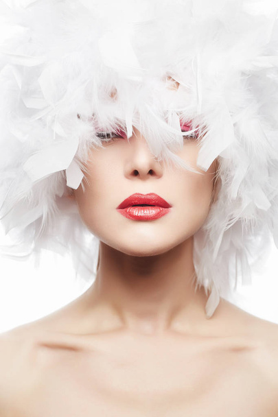 Beautiful Woman with red lips and white feathers - Photo, Image