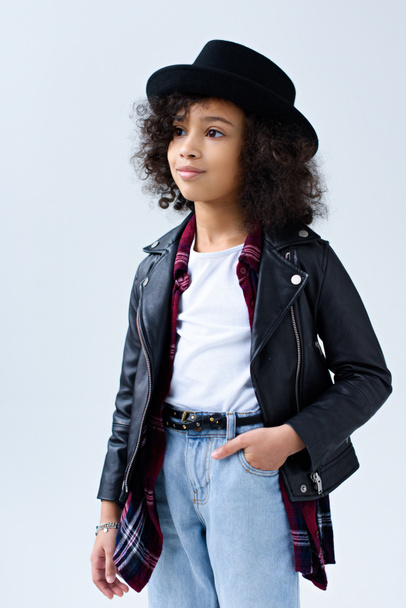 stylish little child in leather jacket looking away isolated on grey - Фото, изображение