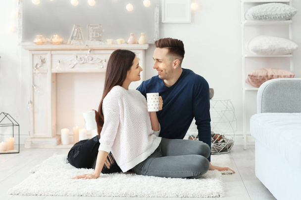 Young couple spending time together on winter vacation at home - Foto, imagen
