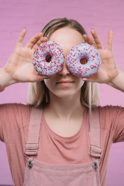 attractive young woman covering eyes with doughnuts - Photo, Image