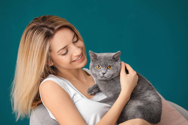 Young woman with cute pet cat at home - Photo, image
